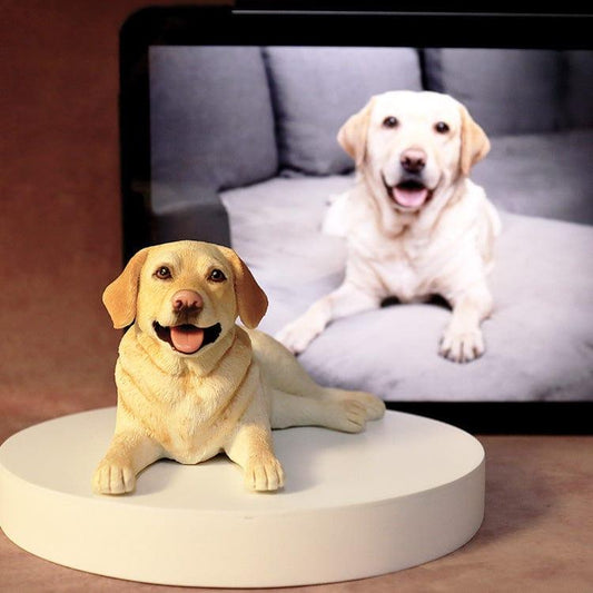 Realistic golden retriever sculpture in front of a tablet computer