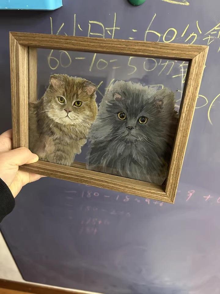 Two pet glass paintings in a picture frame